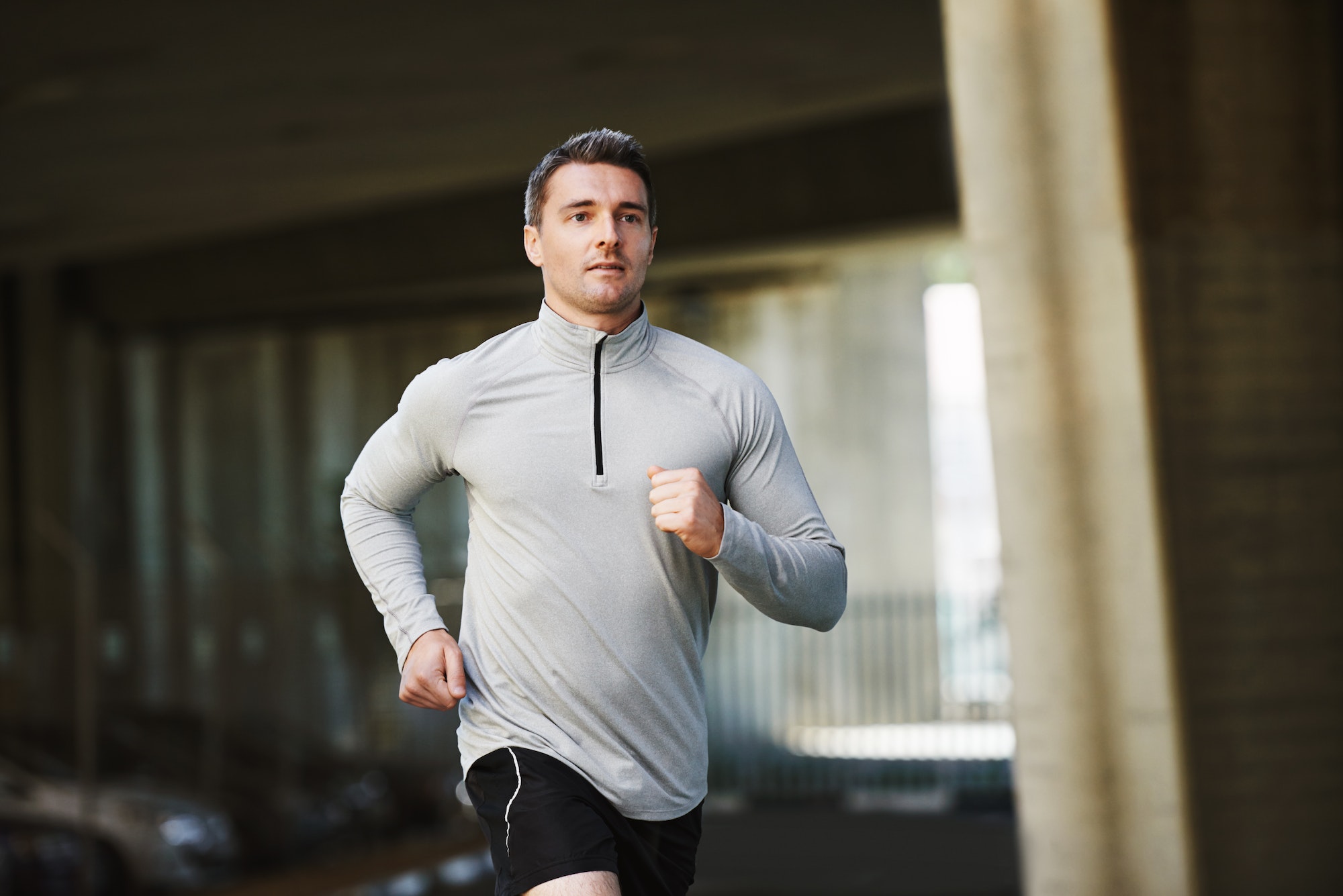 Just running into town. Shot of a sportsman running through the city streets.